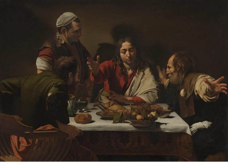 Christ blesses bread as the disciples recognize him in Caravaggio’s Supper at Emmaus.